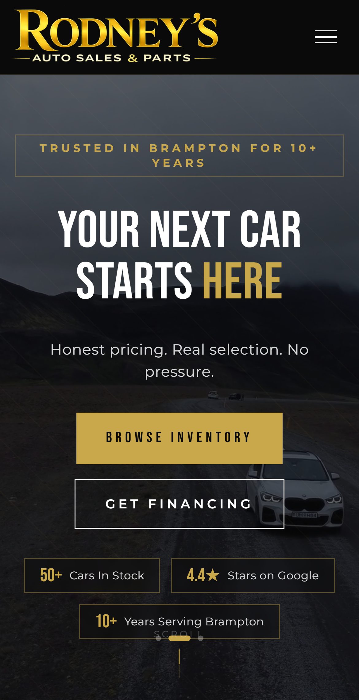 Rodney’s Auto Sales homepage — “Your next car starts here” over a moody mountain road